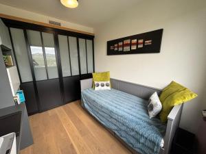 a bedroom with a bed with yellow pillows at La Maison Bernard in Roquefort-la-Bédoule +45 photos