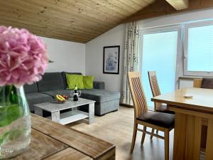 a living room with a couch and a table at Haus Hofer in Bramberg am Wildkogel
