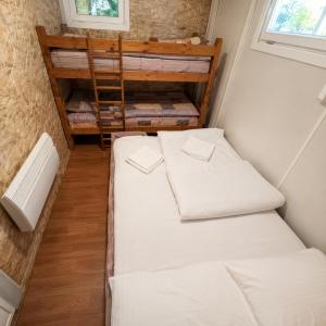 a small room with two beds and a window at Vikendica Ubla in Trebinje