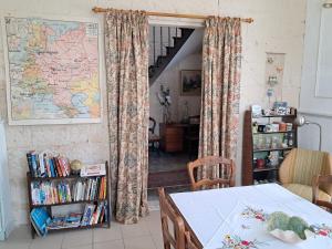 a room with a table and a map on the wall at Thunder Roadhouse in La Mothe-Saint-Héray