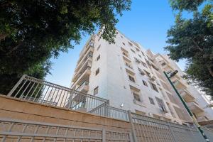 a tall building with a fence in front of it at Spacious Sea-View Penthouse + Big Balconies in Ashdod