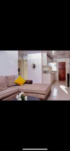 a living room with a couch and a kitchen at ShanazNest in Bulawayo