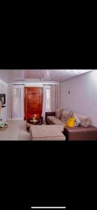 a living room with a couch and a table at ShanazNest in Bulawayo