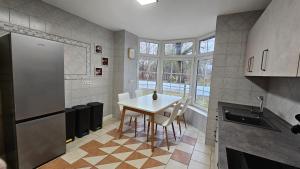 a kitchen with a table and chairs in a room at Fewo-OPR de Billi in Wusterhausen