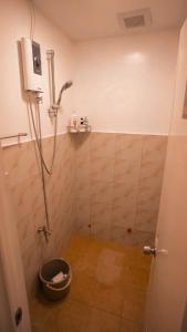 a bathroom with a shower with a bucket at Balay Salazar in Malolos +5 photos