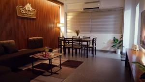 a living room with a table and a dining room at Balay Salazar in Malolos
