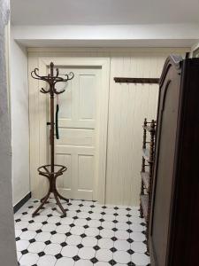 a hallway with a white door and a black and white floor at Staré časy in Chotěboř