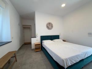 a bedroom with a bed and a clock on the wall at RIAMA AGRIRESORT in Naples