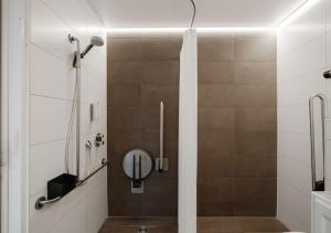 a bathroom with a shower with a glass door at Duindomein Ter Helme in Oostduinkerke +34 photos