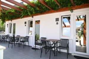 a group of tables and chairs on a patio at Casa De Hijos in Cavtat