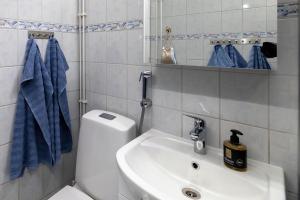 a bathroom with a white toilet and a sink at 3 bedrooms house with garden in Rauma +14 photos