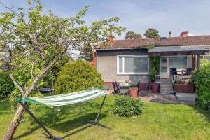 a hammock in the yard of a house at 3 bedrooms house with garden in Rauma