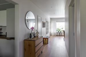 a room with a dresser and a mirror on the wall at 3 bedrooms house with garden in Rauma