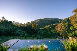 a swimming pool with a mountain in the background at Ella 100 View Cottage in Ella +62 photos