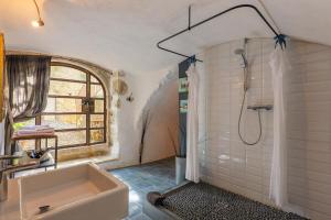 a bathroom with a tub and a shower and a sink at Le Mas D'alzon in Vagnas +58 photos