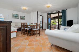 a living room with a couch and a table at Brezza Smeralda- Costa Smeralda in Cala Bitta