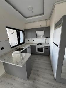 a kitchen with a sink and a counter top at Ak Suites Rezidans in Trabzon