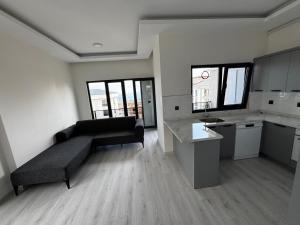 a living room with a couch and a kitchen at Ak Suites Rezidans in Trabzon