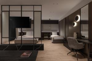 a bedroom with two beds and a desk with a television at Union43 Ioannina in Ioannina
