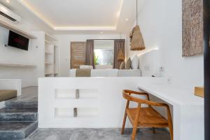 a white kitchen with a desk and a bedroom at Villa Ruta II - Luxury 2BR Tropical Villa next to Luna Beach Club and Nyanyi beach in Tanah Lot +22 photos