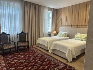 a hotel room with two beds and two chairs at Hotel Jipek Joli in Nukus +28 photos