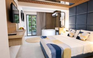 a bedroom with a large bed and a bathroom at Mesona Hotels Blue Hill in Antalya