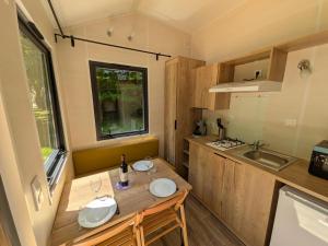 a small kitchen with a table in a tiny house at Tiny house in Saint-Côme-dʼOlt +2 photos