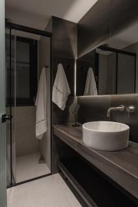a bathroom with a white sink and a shower at Union43 Ioannina in Ioannina +21 photos