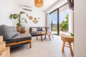 a living room with a couch and a table at ELGIAN Luxury Villa -Private Pool & Sea View in Póndi