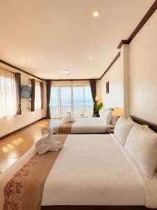 a hotel room with two beds and a couch at ClayHouse SAMUI Boutique Hotel in Koh Samui +72 photos