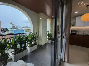 a room with a balcony with plants and a view at Cưng Homestay SG in Ho Chi Minh City