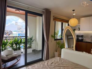 a bedroom with a bed and a balcony at Cưng Homestay SG in Ho Chi Minh City