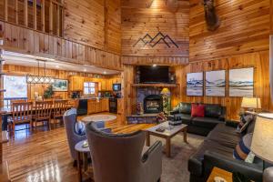 a living room and kitchen in a log home at Riverbend Retreat in Todd