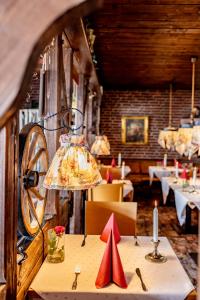 a dining room with a table with a lamp on it at Hotel Friese in Norderney