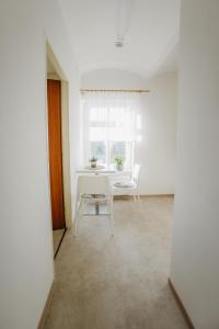 a white room with a white table and a chair at Penzion Albertovec in Opava