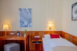 a hotel room with a bed and a desk and a bed sidx sidx sidx sidx at Hotel Friese in Norderney +48 photos