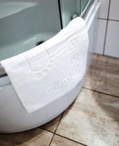 a white toilet sitting on the floor in a bathroom at Svit home Hamster 007- apart-hotel in Lviv +23 photos