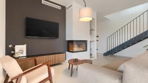 a living room with a tv and a fireplace at Villa Moia by Villas Guide in Kaštelir