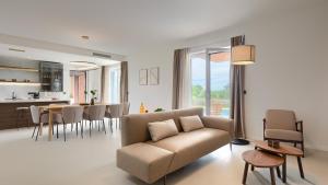 a living room with a couch and a kitchen at Villa Moia by Villas Guide in Kaštelir