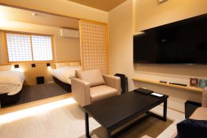 a room with a living room with a bed and a tv at 別府 夕凪 in Beppu