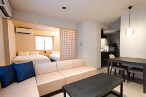 a living room with a couch and a bed and a table at 別府 夕凪 in Beppu