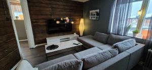 a living room with a couch and a tv at The Yellow House in Boden