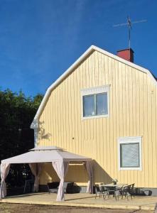 a yellow building with a table and an umbrella at The Yellow House in Boden