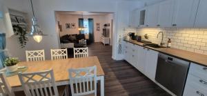 a kitchen and living room with a table and a counter at The Yellow House in Boden