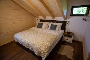 a bedroom with a large bed in a room at Macaklin Fužine in Fužine