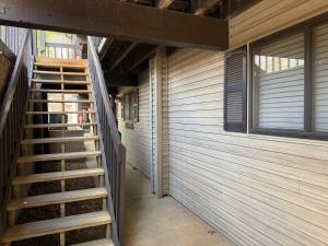 a wooden staircase leading to a building with windows at LOTO fun at 21 Lakeview Condo in Osage Beach +27 photos