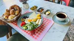 a table with a plate of food and a cup of coffee at RUSH HOTEL İSTANBUL in Istanbul +47 photos