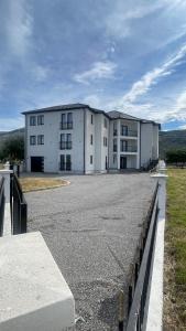 a large white building in the middle of a road at SunVillaTuzi in Tuzi