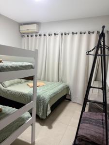 a room with two bunk beds and a ladder at Sobrado NOVO próximo BR 290 in São Gabriel