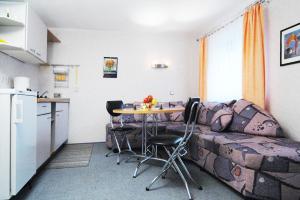 a living room with a couch and a table with chairs at Haus Bauer Ferienwohnung 1 in Wasserburg